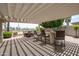 Outdoor kitchen and dining area with a pergola, bar seating, and a scenic backyard view at 3441 N 162Nd Ln, Goodyear, AZ 85395