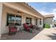 Covered patio with comfortable wicker furniture, perfect for relaxing and enjoying the outdoor space at 3441 N 162Nd Ln, Goodyear, AZ 85395