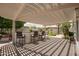 Covered patio with outdoor bar featuring counter seating, providing a perfect space for entertaining at 3441 N 162Nd Ln, Goodyear, AZ 85395