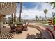 Outdoor dining area with stylish wicker chairs and a built-in bench seat, ideal for entertaining guests at 3441 N 162Nd Ln, Goodyear, AZ 85395