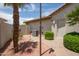 Side yard with desert landscaping, rocks, a walkway, palm trees, and an air conditioning unit at 3441 N 162Nd Ln, Goodyear, AZ 85395