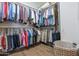 Well-organized walk-in closet with hanging clothes, shelving, and a laundry basket at 3441 N 162Nd Ln, Goodyear, AZ 85395