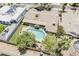 Lovely aerial view showcasing the house, pool, patio, landscaping and surrounding greenery at 402 E Claremont St, Phoenix, AZ 85012