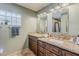Elegant bathroom with dual sinks, granite countertops, and modern fixtures at 402 E Claremont St, Phoenix, AZ 85012