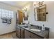 Bathroom featuring double sinks with modern fixtures, stylish mirrors, and sleek vanity at 402 E Claremont St, Phoenix, AZ 85012
