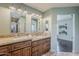 Well-lit bathroom with dual sinks, granite countertops, and modern accents at 402 E Claremont St, Phoenix, AZ 85012