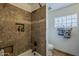 Bathroom featuring shower with tiled surround, built-in shelves and a bathtub at 402 E Claremont St, Phoenix, AZ 85012