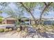 Charming single-story home with desert landscaping, mature trees and a brick exterior at 402 E Claremont St, Phoenix, AZ 85012