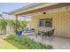 Cozy covered patio with hanging swing, comfortable seating and relaxing garden views at 402 E Claremont St, Phoenix, AZ 85012