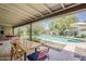 Outdoor patio featuring dining table, seating and relaxing views of the pool and yard at 402 E Claremont St, Phoenix, AZ 85012