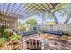 Outdoor brick patio area featuring a metal seating and a metal pergola with ambient string lights at 402 E Claremont St, Phoenix, AZ 85012