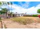 Expansive backyard featuring a covered patio, mature trees, and room for outdoor activities at 4062 W Mescal St, Phoenix, AZ 85029