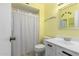 A cozy bathroom featuring a vanity sink and a shower with a white curtain at 4062 W Mescal St, Phoenix, AZ 85029