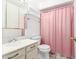 Bathroom with a vanity sink, toilet, and shower with a pink curtain at 4062 W Mescal St, Phoenix, AZ 85029