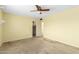 Spacious bedroom with neutral colored walls, a ceiling fan, standard-sized windows, and carpet at 4062 W Mescal St, Phoenix, AZ 85029