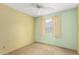 Cozy bedroom with a ceiling fan, a window with curtains at 4062 W Mescal St, Phoenix, AZ 85029