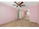 Cozy bedroom with ceiling fan, closet, and pink walls at 4062 W Mescal St, Phoenix, AZ 85029