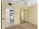 Bedroom with a sliding door closet and an open doorway to another room at 4062 W Mescal St, Phoenix, AZ 85029