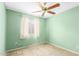 Bedroom featuring light green walls, a ceiling fan, and a window at 4062 W Mescal St, Phoenix, AZ 85029