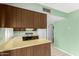 Functional kitchen area with wooden cabinets, countertops, standard appliances, and neutral color at 4062 W Mescal St, Phoenix, AZ 85029