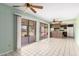 Bright kitchen area featuring sliding glass doors, ceiling fans, and a compact kitchenette at 4062 W Mescal St, Phoenix, AZ 85029