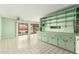Bright living room with tile flooring, custom shelving, and access to the backyard at 4062 W Mescal St, Phoenix, AZ 85029