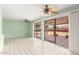 Bright living room with sliding glass doors to the patio, ceiling fans, and tile floors at 4062 W Mescal St, Phoenix, AZ 85029
