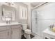 Clean bathroom with a glass shower, white toilet, vanity, and a large mirror at 4142 E Sandy Way, Gilbert, AZ 85297
