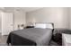 Well-lit bedroom with neutral walls, wood floors, a comfortable bed, and a white door at 4142 E Sandy Way, Gilbert, AZ 85297