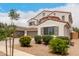 A delightful two-story house with a red tile roof and lush greenery, showcasing the home's curb appeal at 4142 E Sandy Way, Gilbert, AZ 85297