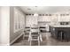 Bright eat-in kitchen featuring white cabinets, stainless appliances, and gray-toned wood floors at 4142 E Sandy Way, Gilbert, AZ 85297