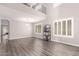 Living room with vaulted ceiling, wood floors, neutral walls, and abundant natural light from large windows at 4142 E Sandy Way, Gilbert, AZ 85297