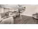 Open-concept living room flows into kitchen, featuring neutral decor, wood floors, and ample seating at 4142 E Sandy Way, Gilbert, AZ 85297