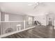 Bright open loft features wood floors, iron railing, and views of downstairs at 4142 E Sandy Way, Gilbert, AZ 85297