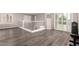Spacious loft area with wood floors, iron railing, and large windows offering ample natural light at 4142 E Sandy Way, Gilbert, AZ 85297