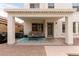 Covered patio with comfortable seating, a ceiling fan, and access to the backyard at 4142 E Sandy Way, Gilbert, AZ 85297