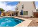 Inviting pool surrounded by brick pavers, blue umbrellas and a covered patio, perfect for outdoor living at 4142 E Sandy Way, Gilbert, AZ 85297
