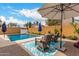 Relaxing poolside view with comfortable seating, ample shade, and a sparkling pool, perfect for outdoor enjoyment at 4142 E Sandy Way, Gilbert, AZ 85297