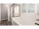 This bathroom features a white soaking tub and glass enclosed shower with white tile surround at 4142 E Sandy Way, Gilbert, AZ 85297