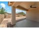 Relaxing back patio with ceiling fan, brick accents, and view of the backyard at 43884 W Kramer Ln, Maricopa, AZ 85138