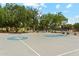 Community basketball court with mature trees and shaded seating at 43884 W Kramer Ln, Maricopa, AZ 85138