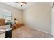 Spare bedroom ready for moving, with carpeting and large window with blinds at 43884 W Kramer Ln, Maricopa, AZ 85138