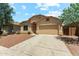 Well-kept single-story home with desert landscaping and a spacious driveway leading to a garage at 43884 W Kramer Ln, Maricopa, AZ 85138