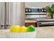 Close up of stainless steel range oven with modern knobs and stainless fridge at 43884 W Kramer Ln, Maricopa, AZ 85138