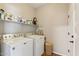 The laundry room features a washer, dryer, and storage space at 43884 W Kramer Ln, Maricopa, AZ 85138
