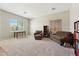 Spacious carpeted living room with ample natural light, and comfortable seating at 43884 W Kramer Ln, Maricopa, AZ 85138