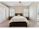 Comfortable main bedroom with a king-size bed, two windows, and matching nightstands at 43884 W Kramer Ln, Maricopa, AZ 85138