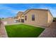This is a backyard with artificial turf and a paved patio perfect for entertaining and relaxation at 4424 W Vervain Ave, San Tan Valley, AZ 85144
