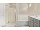 Bathroom with walk-in shower, soaking tub, dual sink vanity, and neutral color palette at 4424 W Vervain Ave, San Tan Valley, AZ 85144