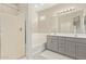 Bathroom with walk-in shower, soaking tub, dual sink vanity, and neutral color palette at 4424 W Vervain Ave, San Tan Valley, AZ 85144